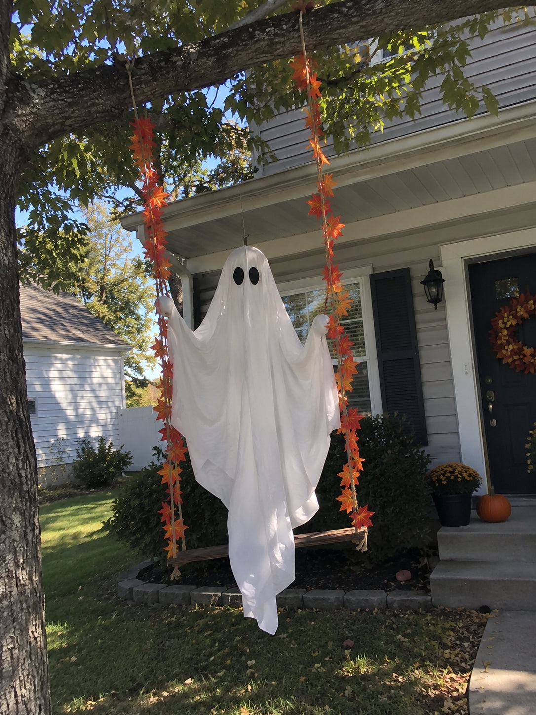 Light-up swinging ghost displayed outside a customer’s home